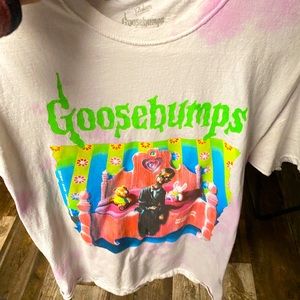 Goosebumps shirt from Journeys it is pink, green, purple, white, and black.